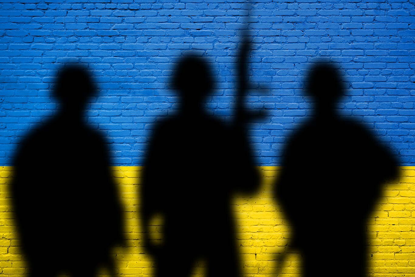 Soldier shadows on Ukraine flag wall