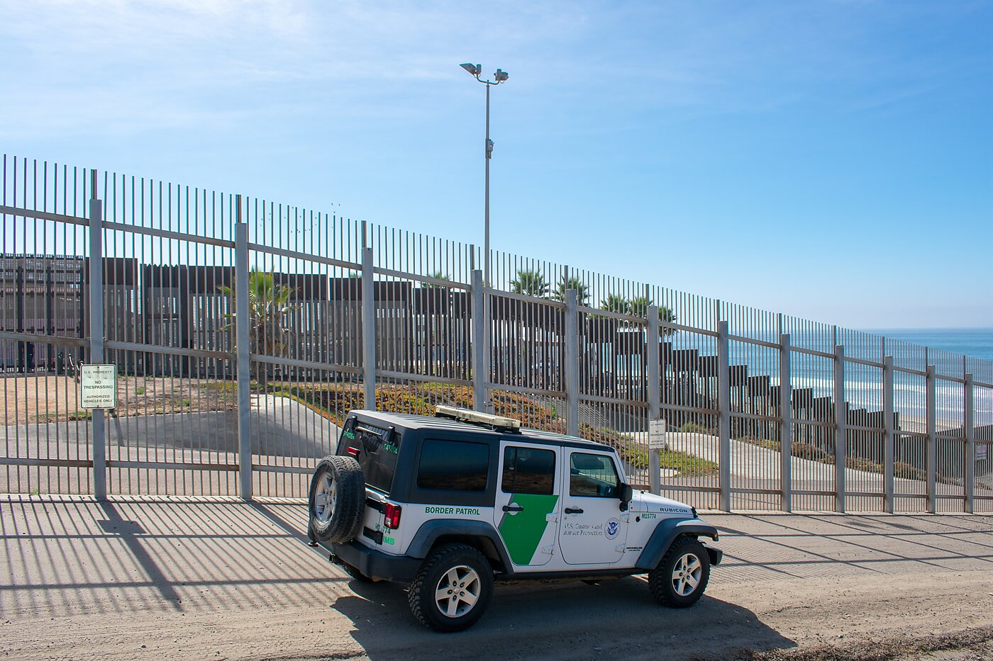 US Border Patrol jeep along the US-Mexico border fence