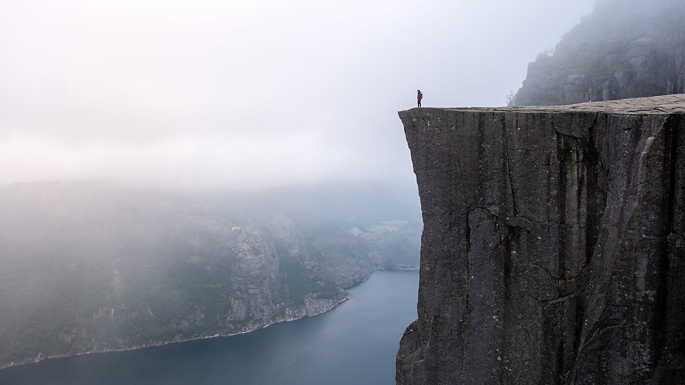 A man standing on the edge of a cliff